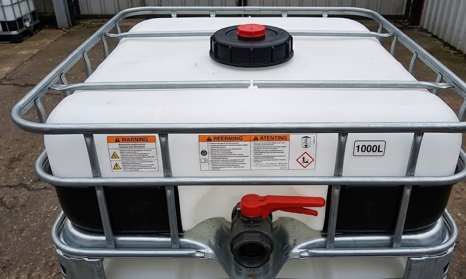 Close-up of IBC tote cap, valve, and safety labels